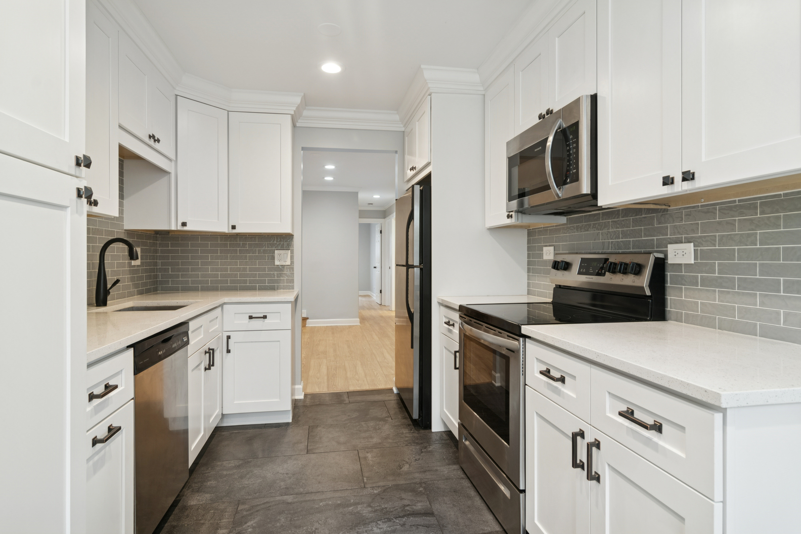 184 Grove Avenue, Unit B Des Plaines, IL 60016 - Photo 10 of 20 a kitchen with stainless steel appliances a stove microwave and refrigerator