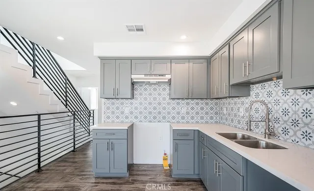 a kitchen with a sink and cabinets