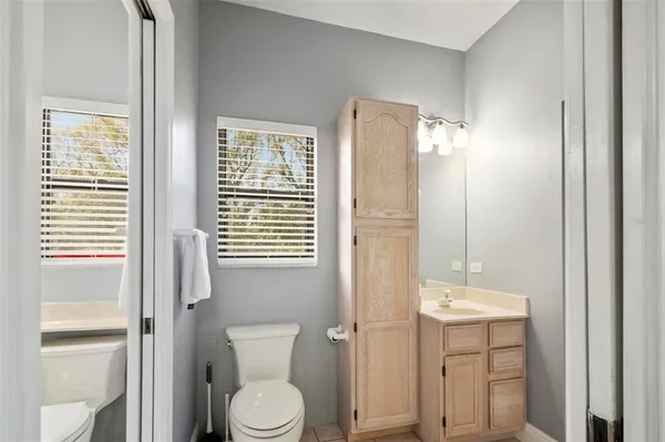 a bathroom with a toilet a sink and a large mirror