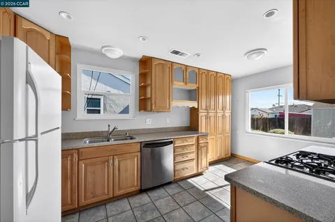 a kitchen with a sink stove and refrigerator