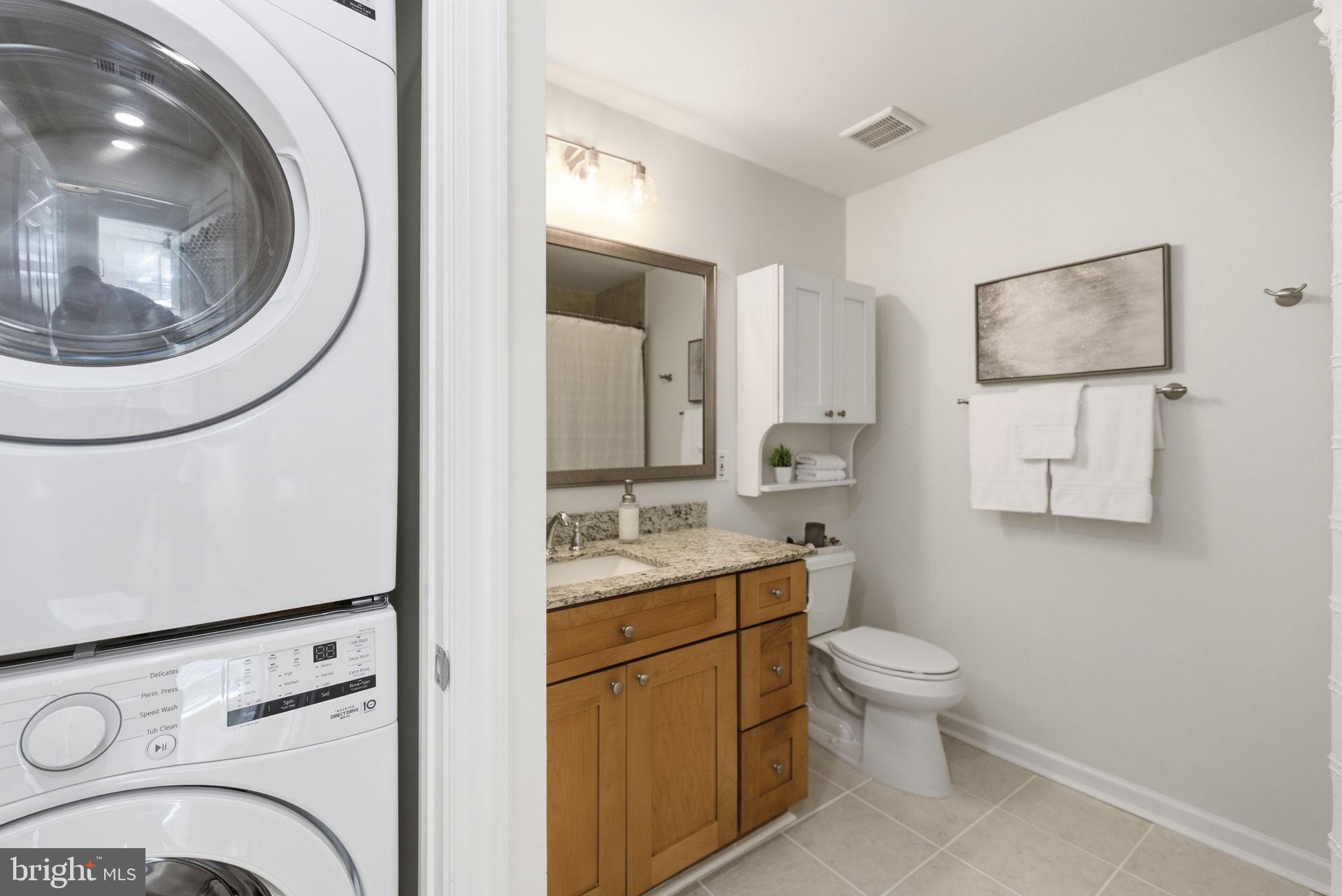 20963 Timber Ridge Terrace, Unit 103 Ashburn, VA 20147 - Photo 16 of 32 a bathroom with a toilet sink and mirror