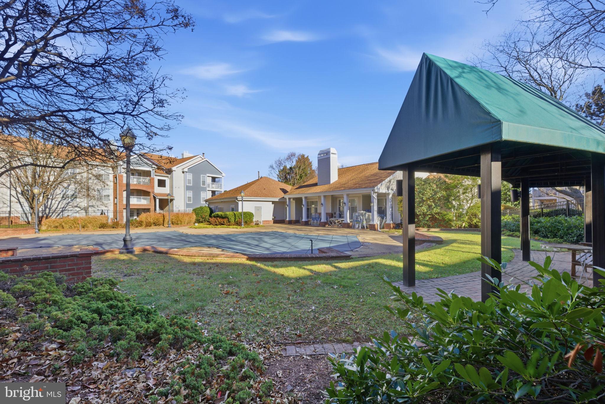 20963 Timber Ridge Terrace, Unit 103 Ashburn, VA 20147 - Photo 21 of 32 a view of a house with swimming pool yard