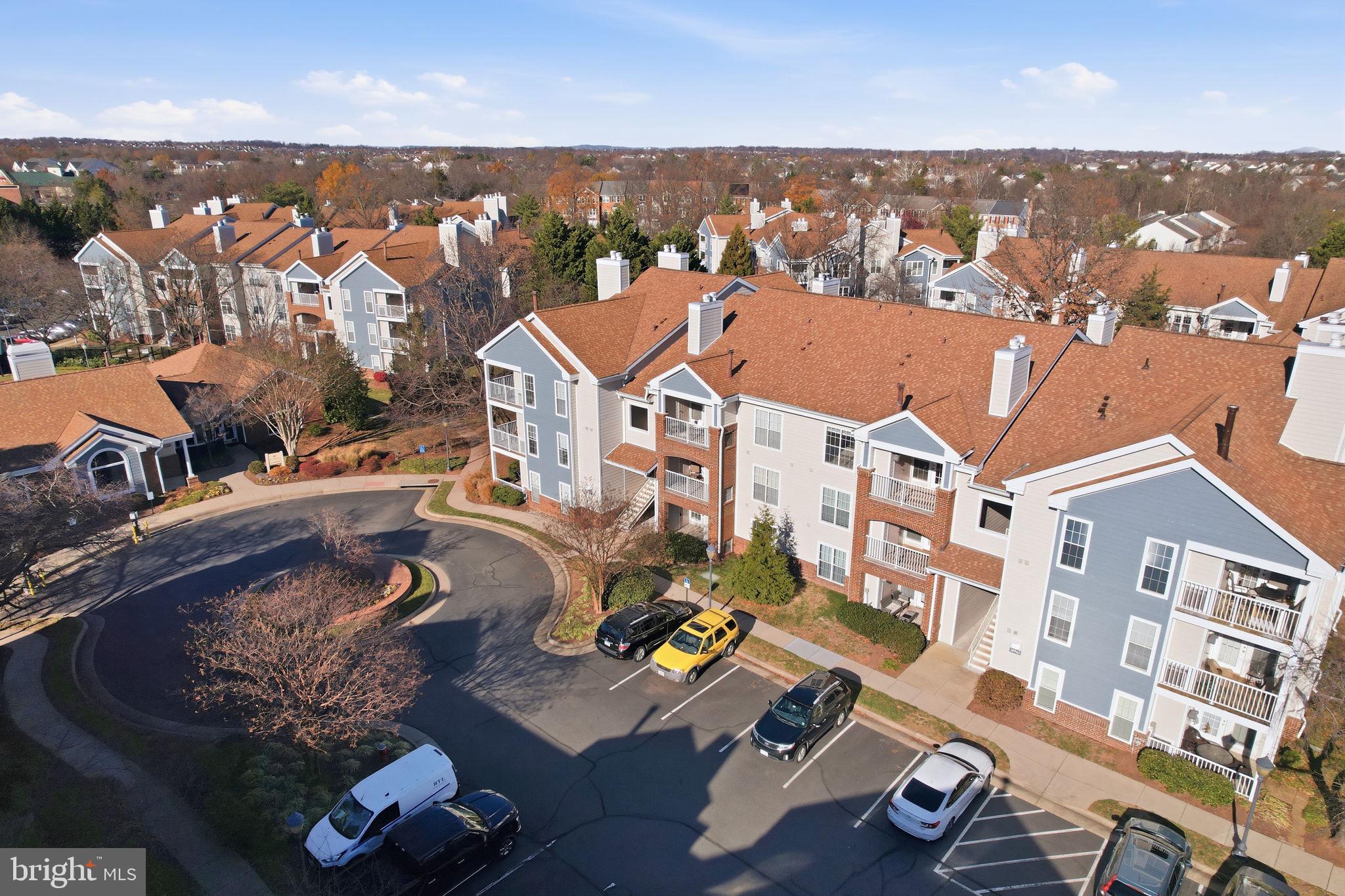 20963 Timber Ridge Terrace, Unit 103 Ashburn, VA 20147 - Photo 29 of 32 an aerial view of residential houses with outdoor space