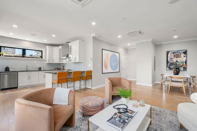 a living room with furniture and kitchen view