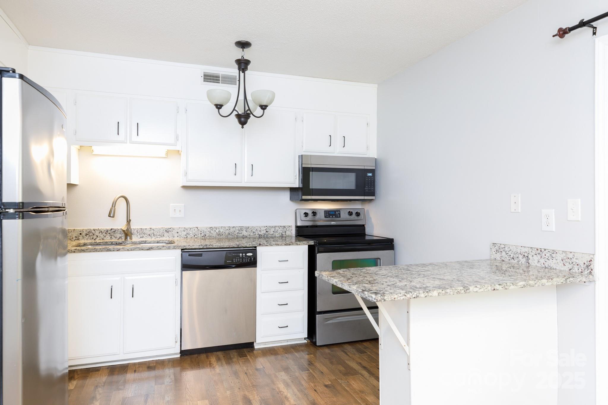 1792 Ebenezer Road, Unit G Rock Hill, SC 29732 - Photo 3 of 28 a kitchen with stainless steel appliances granite countertop a sink stove and refrigerator
