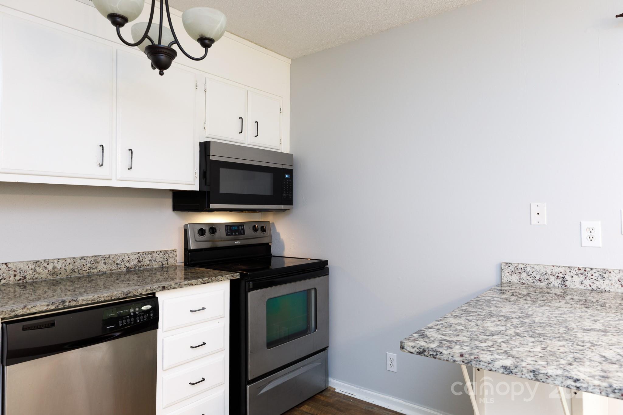 1792 Ebenezer Road, Unit G Rock Hill, SC 29732 - Photo 5 of 28 a kitchen with stainless steel appliances granite countertop a sink and a stove