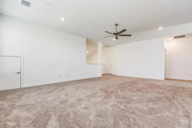 an empty room with fan and ceiling fan