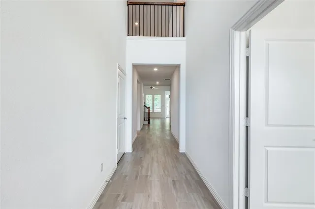 a view of a hallway with wooden floor