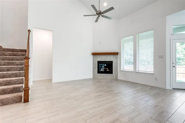 a view of an empty room with a fireplace and a window