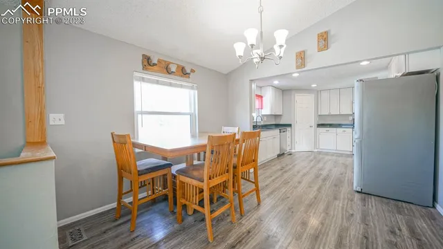 a view of a dining room with furniture and wooden floor