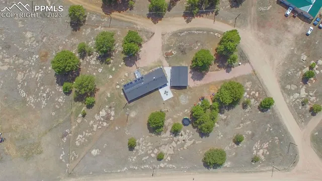 an aerial view of a house with a yard