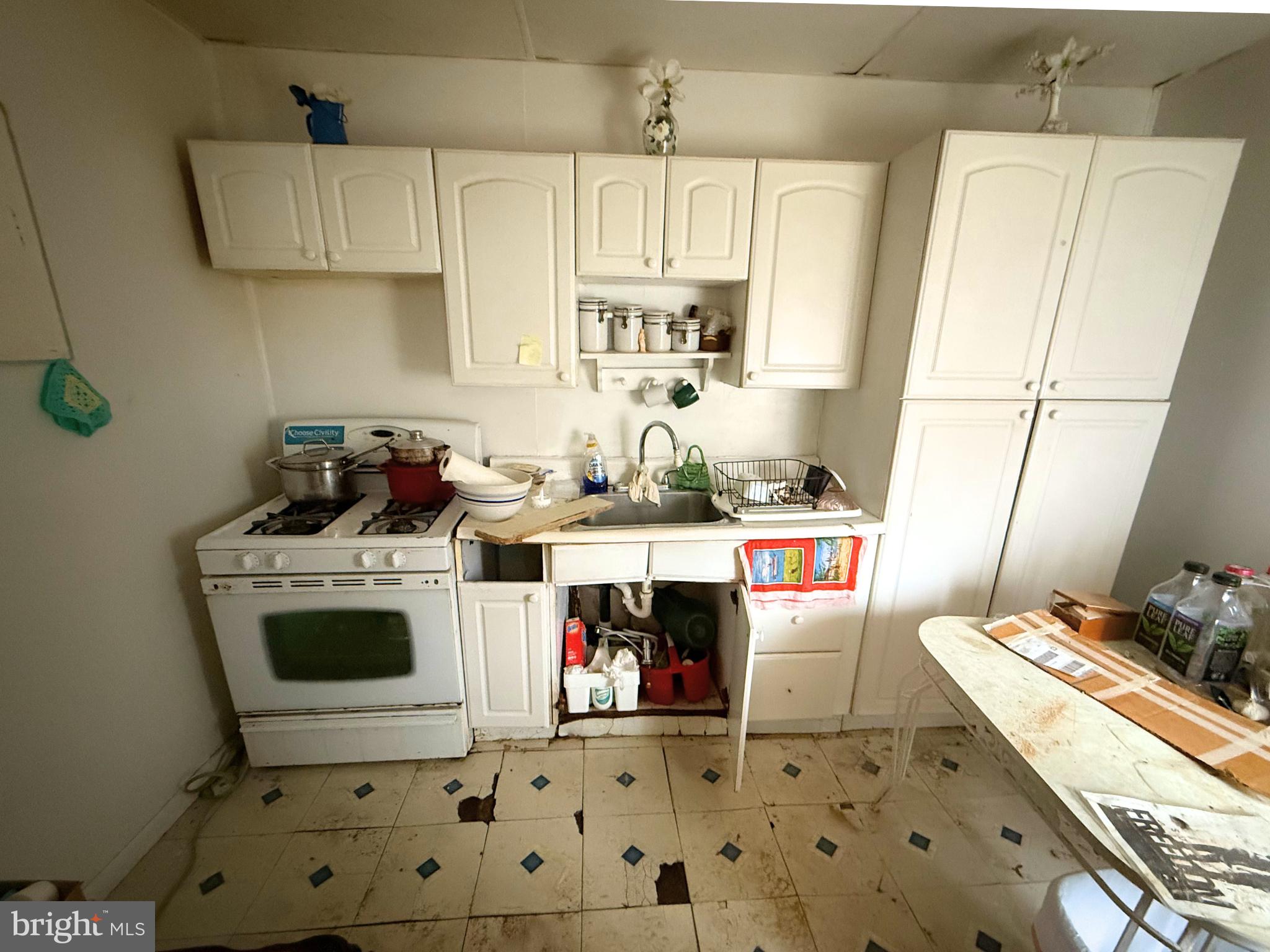 2680 St Benedict Street Baltimore, MD 21223 - Photo 11 of 27 a room with microwave a stove and white cabinets