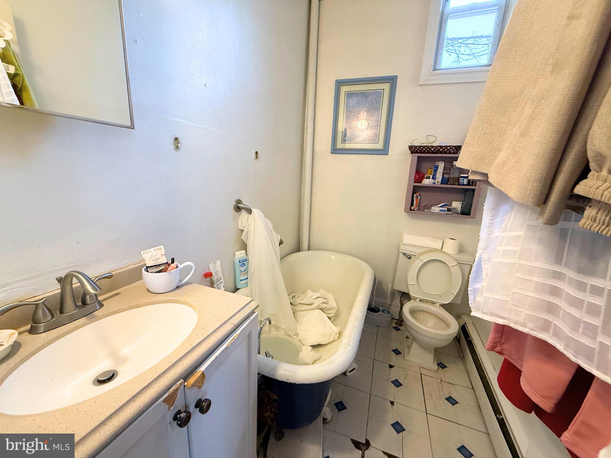 2680 St Benedict Street Baltimore, MD 21223 - Photo 12 of 27 a bathroom with a sink mirror vanity and toilet