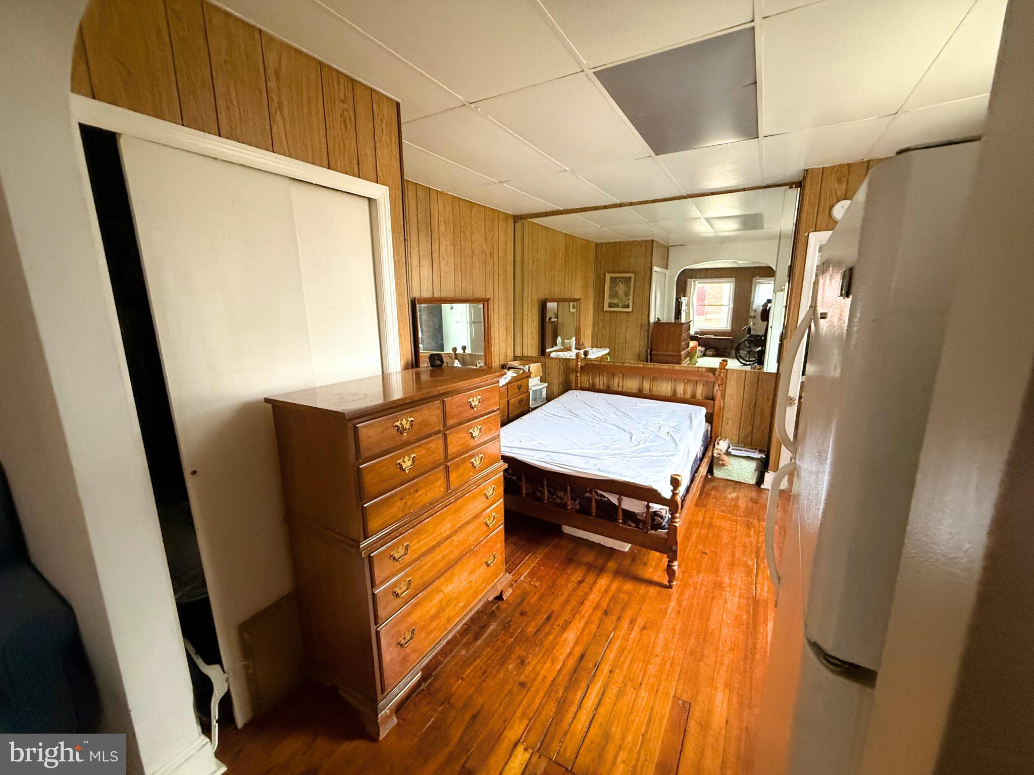 2680 St Benedict Street Baltimore, MD 21223 - Photo 4 of 27 a bedroom with a bed and wooden floor