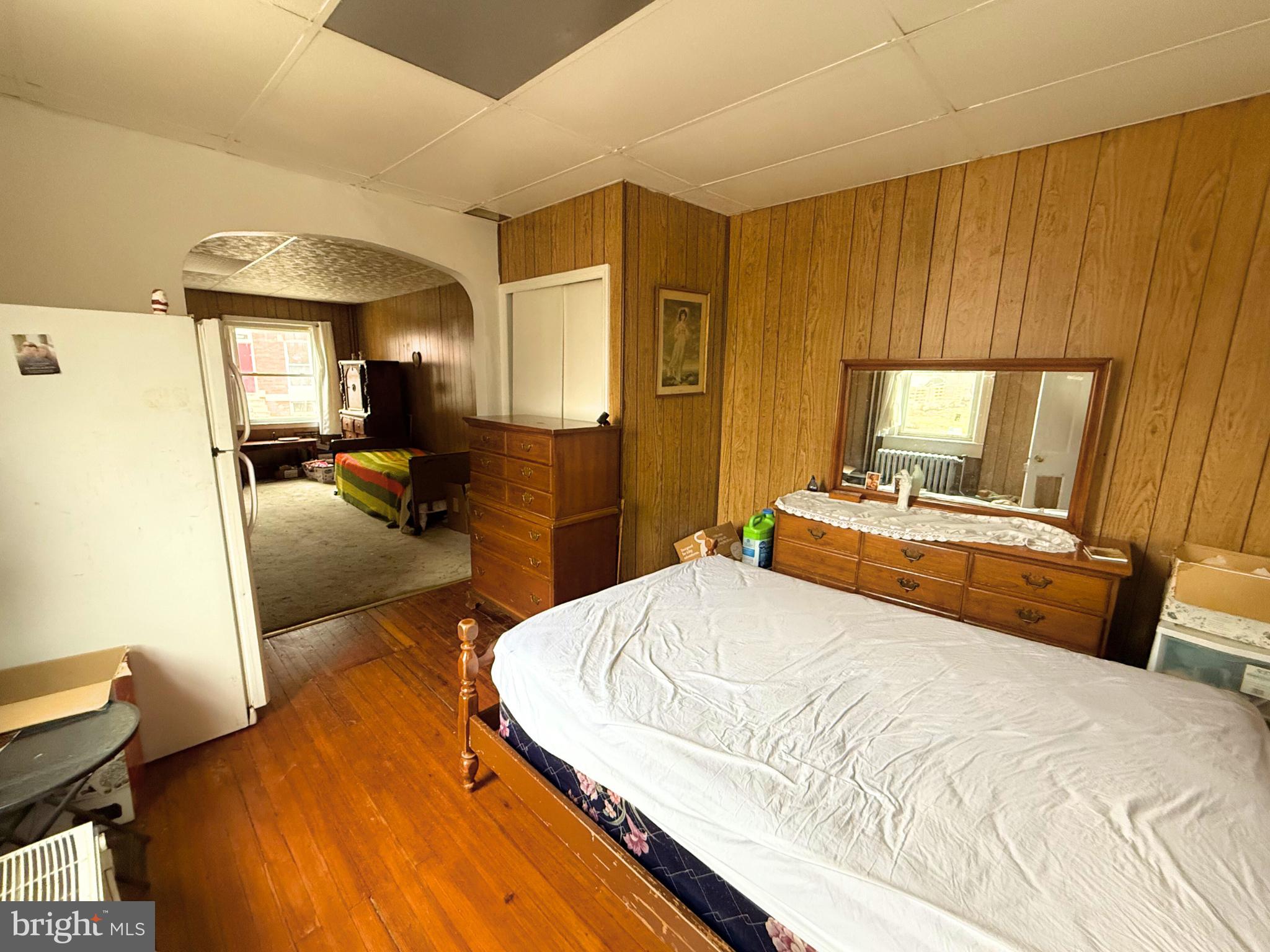 2680 St Benedict Street Baltimore, MD 21223 - Photo 5 of 27 a bedroom with a bed and wooden floor