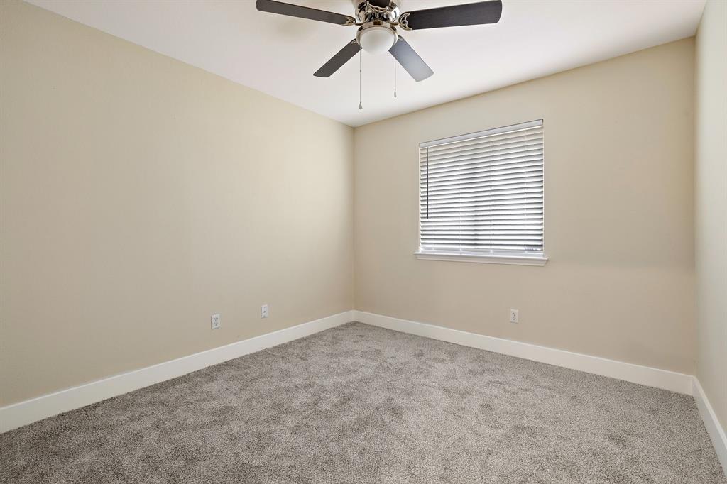 13412 Tossa Lane Austin, TX 78729 - Photo 11 of 16 an empty room with a window and a fan