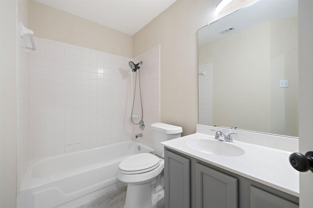 13412 Tossa Lane Austin, TX 78729 - Photo 12 of 16 a bathroom with a sink a toilet and shower