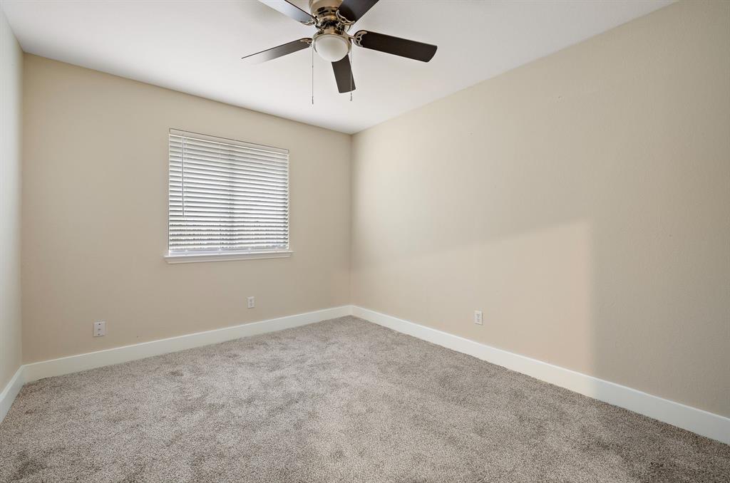 13412 Tossa Lane Austin, TX 78729 - Photo 13 of 16 an empty room with a window and a fan