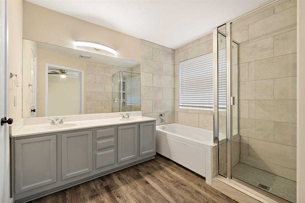 13412 Tossa Lane Austin, TX 78729 - Photo 16 of 16 a bathroom with a tub sink shower and mirror