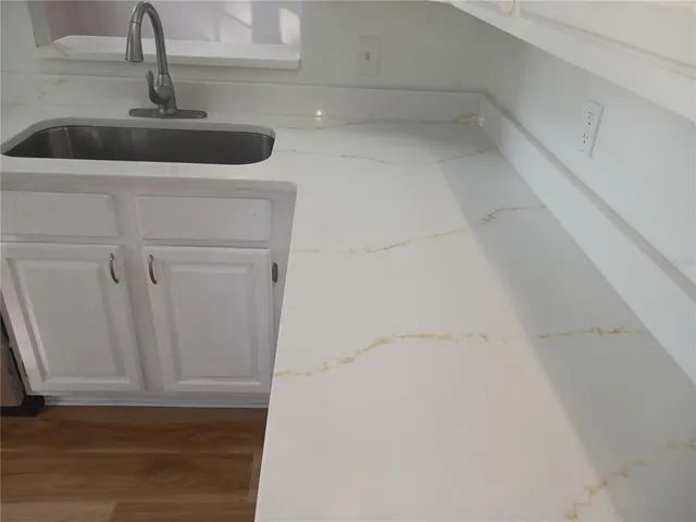 a kitchen with a sink and cabinets