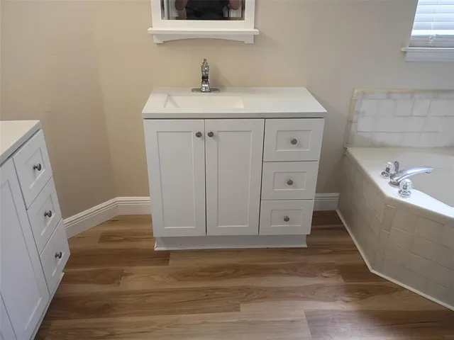 a bathroom with a sink and a mirror