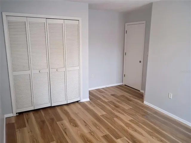 a view of a room with wooden floor