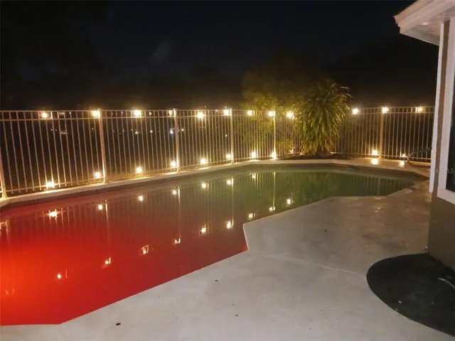 a room with pool table and chairs