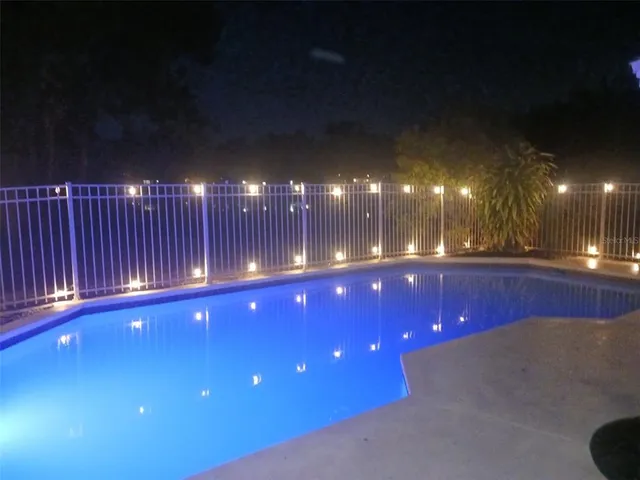 a room with pool table and chairs