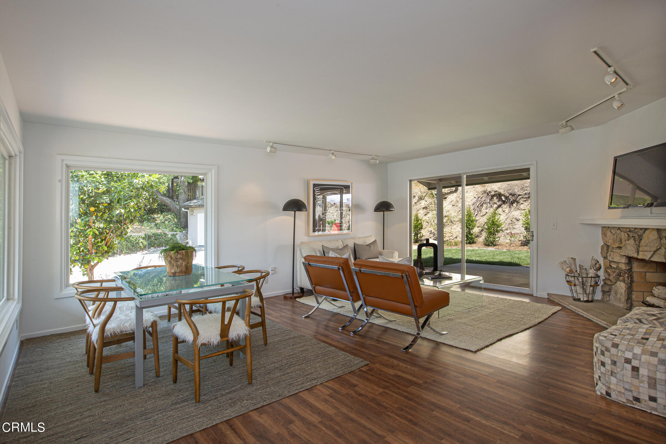 4175 Chevy Chase Drive La Canada Flintridge, CA 91011 - Photo 4 of 40 a living room with furniture a fireplace and a large window