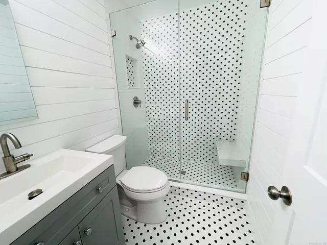 a bathroom with a sink toilet and shower