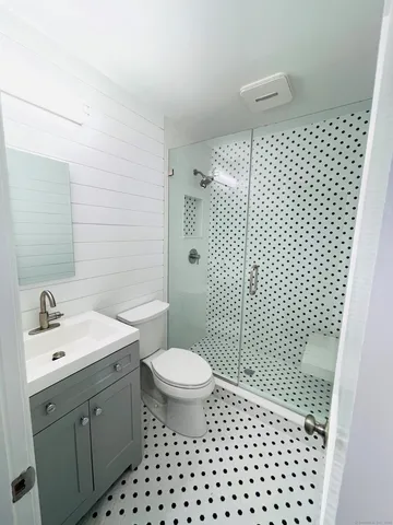 a bathroom with a sink toilet and shower