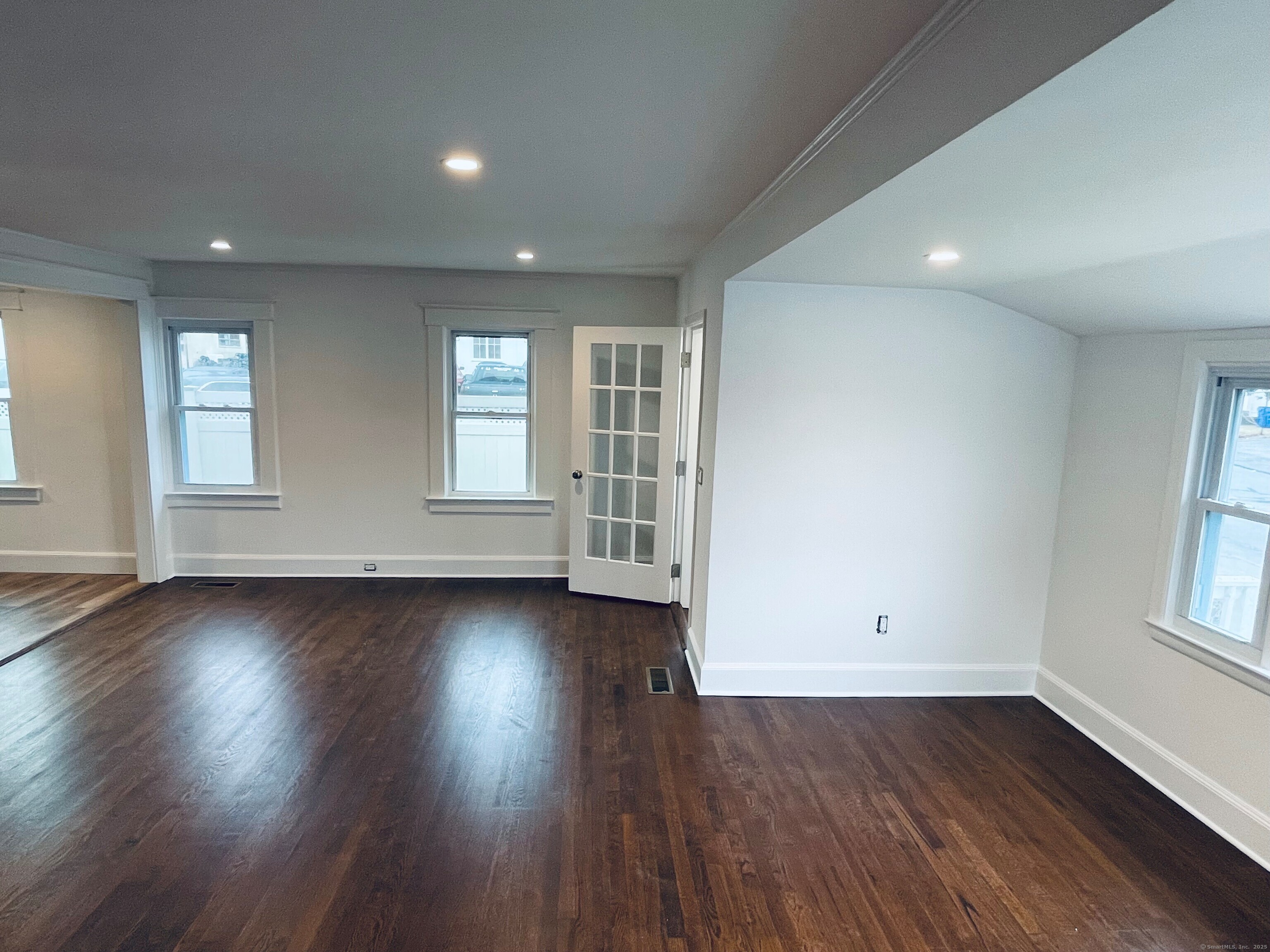317 Strawberry Hill Avenue Norwalk, CT 06851 - Photo 23 of 30 an empty room with wooden floor and windows
