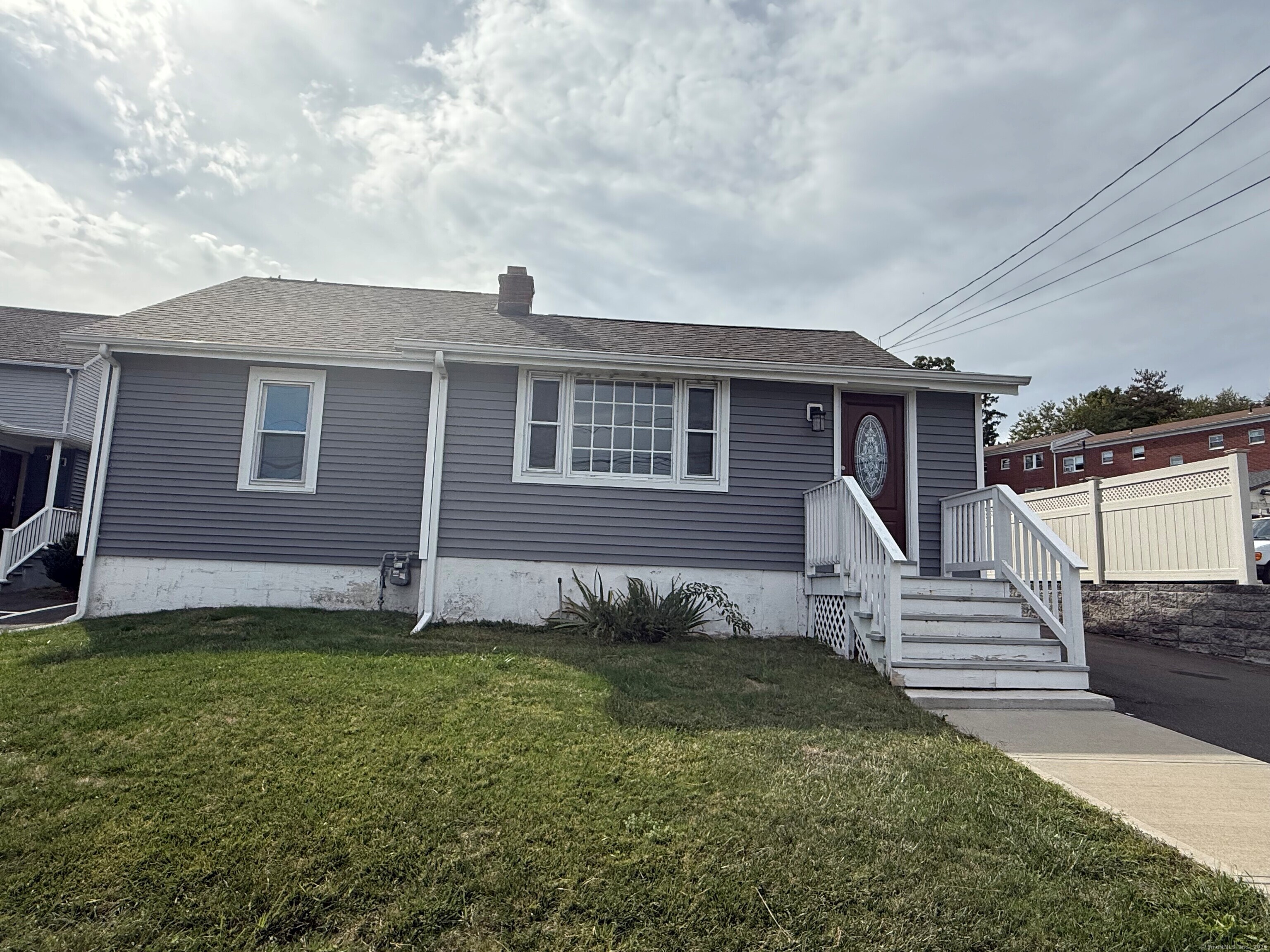 317 Strawberry Hill Avenue Norwalk, CT 06851 - Photo 29 of 30 a front view of a house with a garden