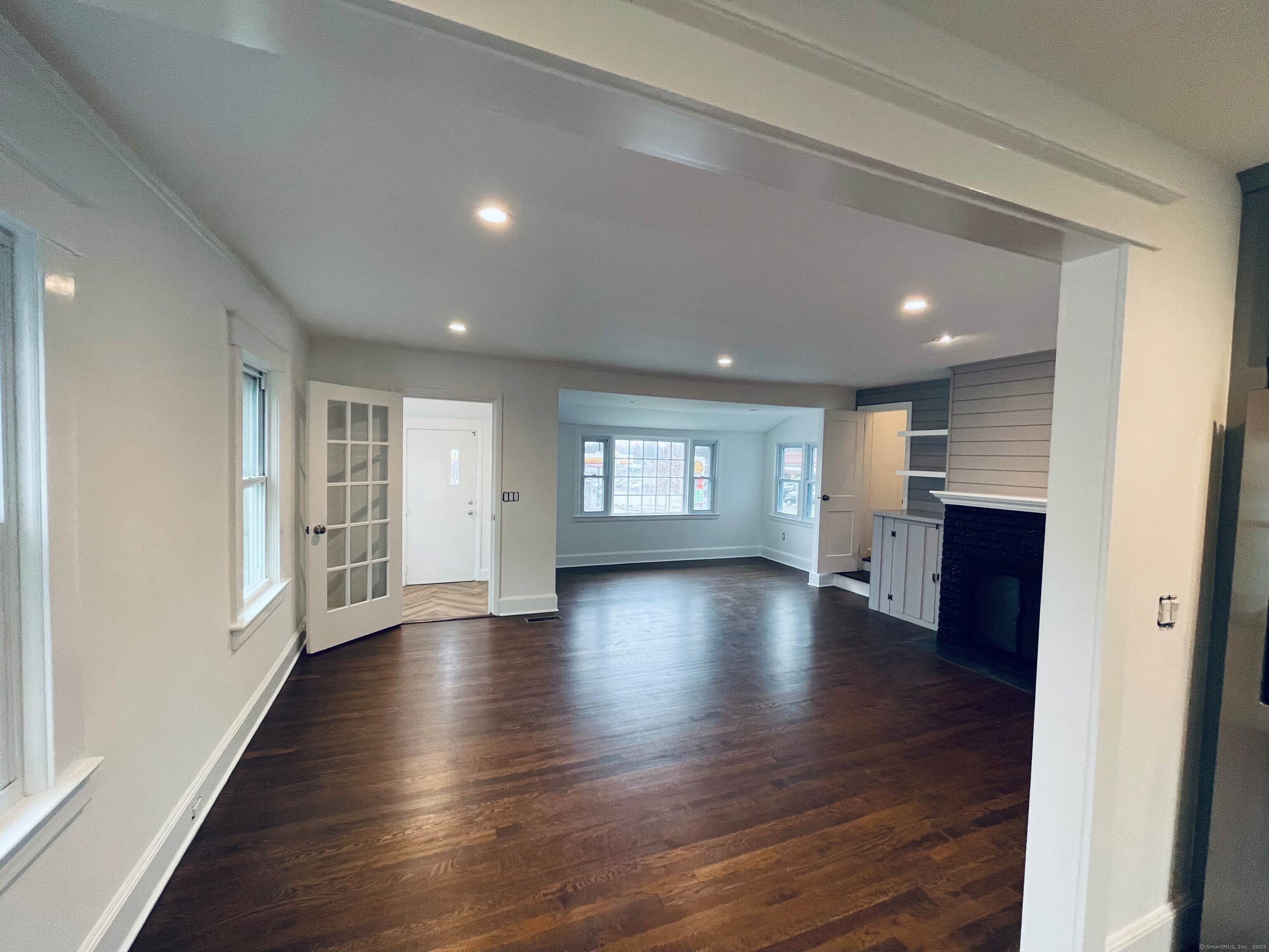 317 Strawberry Hill Avenue Norwalk, CT 06851 - Photo 4 of 30 an empty room with wooden floor and windows