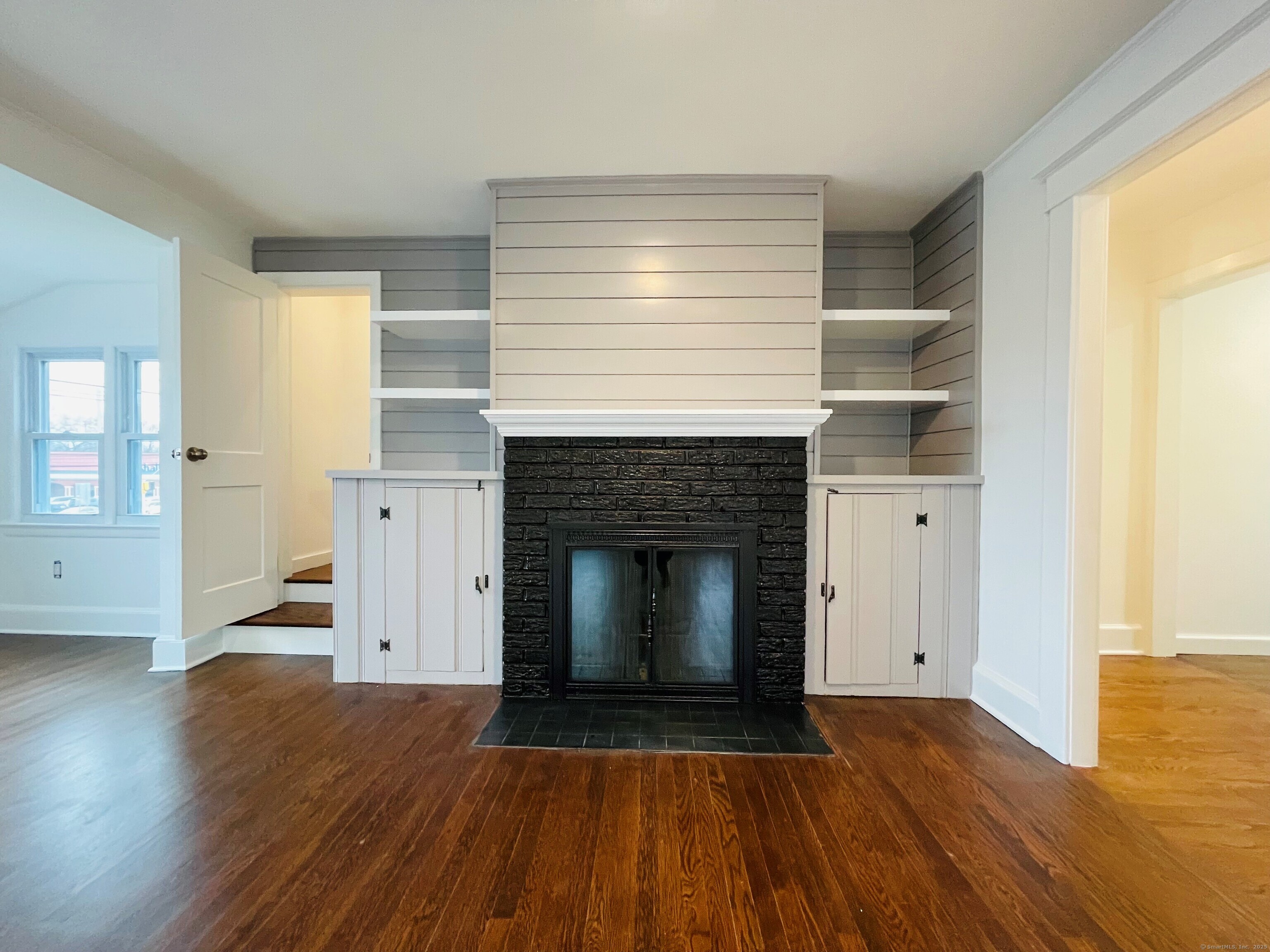 317 Strawberry Hill Avenue Norwalk, CT 06851 - Photo 5 of 30 a view of empty room with wooden floor and fireplace