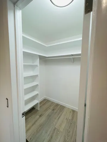 a view of a room with wooden floor and a window