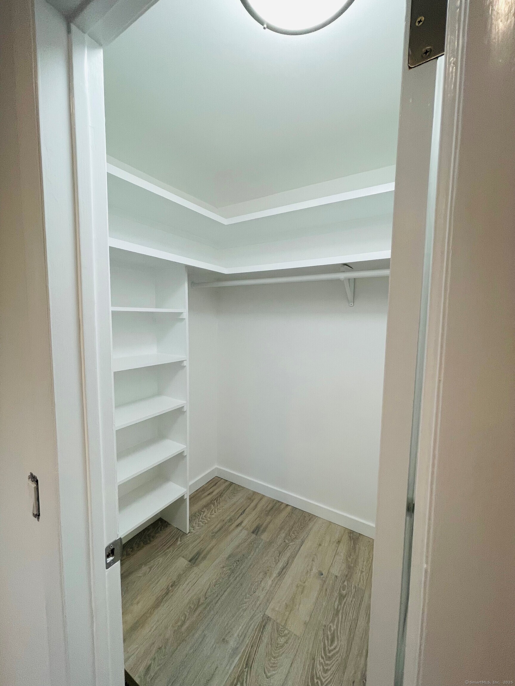 317 Strawberry Hill Avenue Norwalk, CT 06851 - Photo 9 of 30 a view of a room with wooden floor and a window