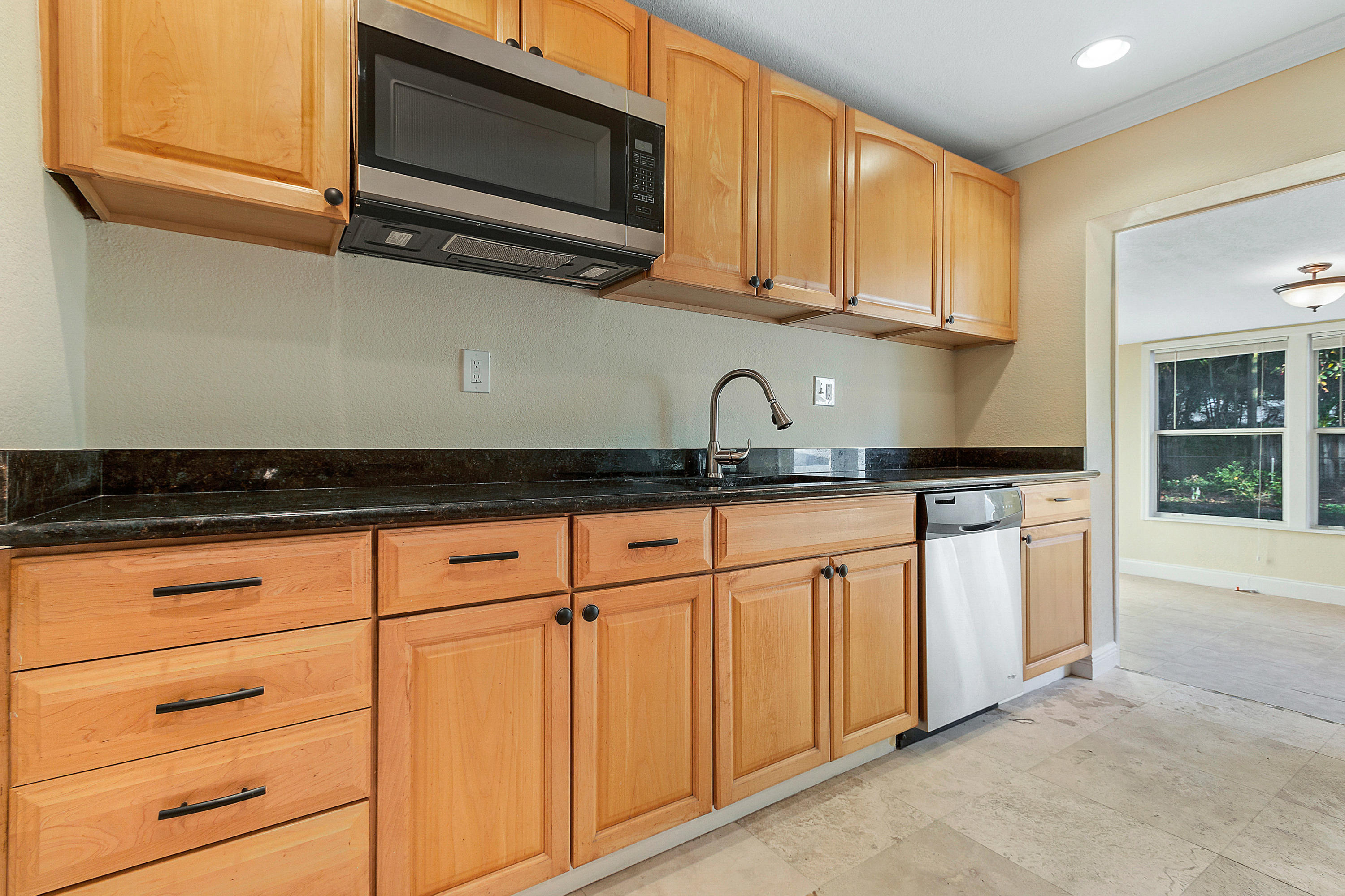 5160 Garfield Road Delray Beach, FL 33484 - Photo 5 of 21 a kitchen with stainless steel appliances granite countertop a sink and a microwave