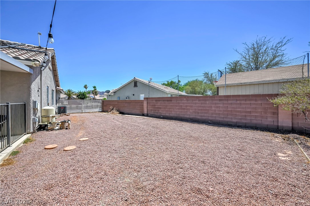 1234 Sunfire Street Henderson, NV 89014 - Photo 39 of 40 A spacious backyard with a durable block fence awaits your personalized touch.