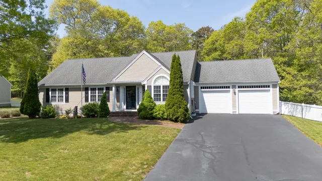 a aerial view of a house with a yard and potted plants