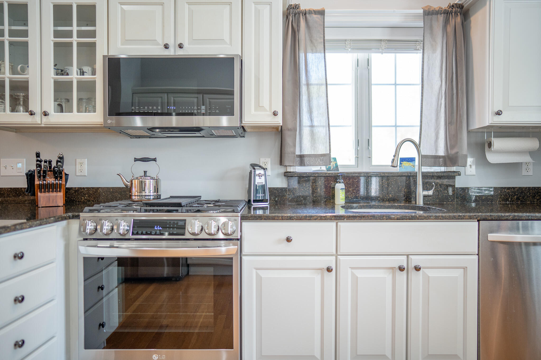 12 Sheffield Place Mashpee, MA 02649 - Photo 13 of 61 a kitchen with stainless steel appliances white cabinets and a stove top oven