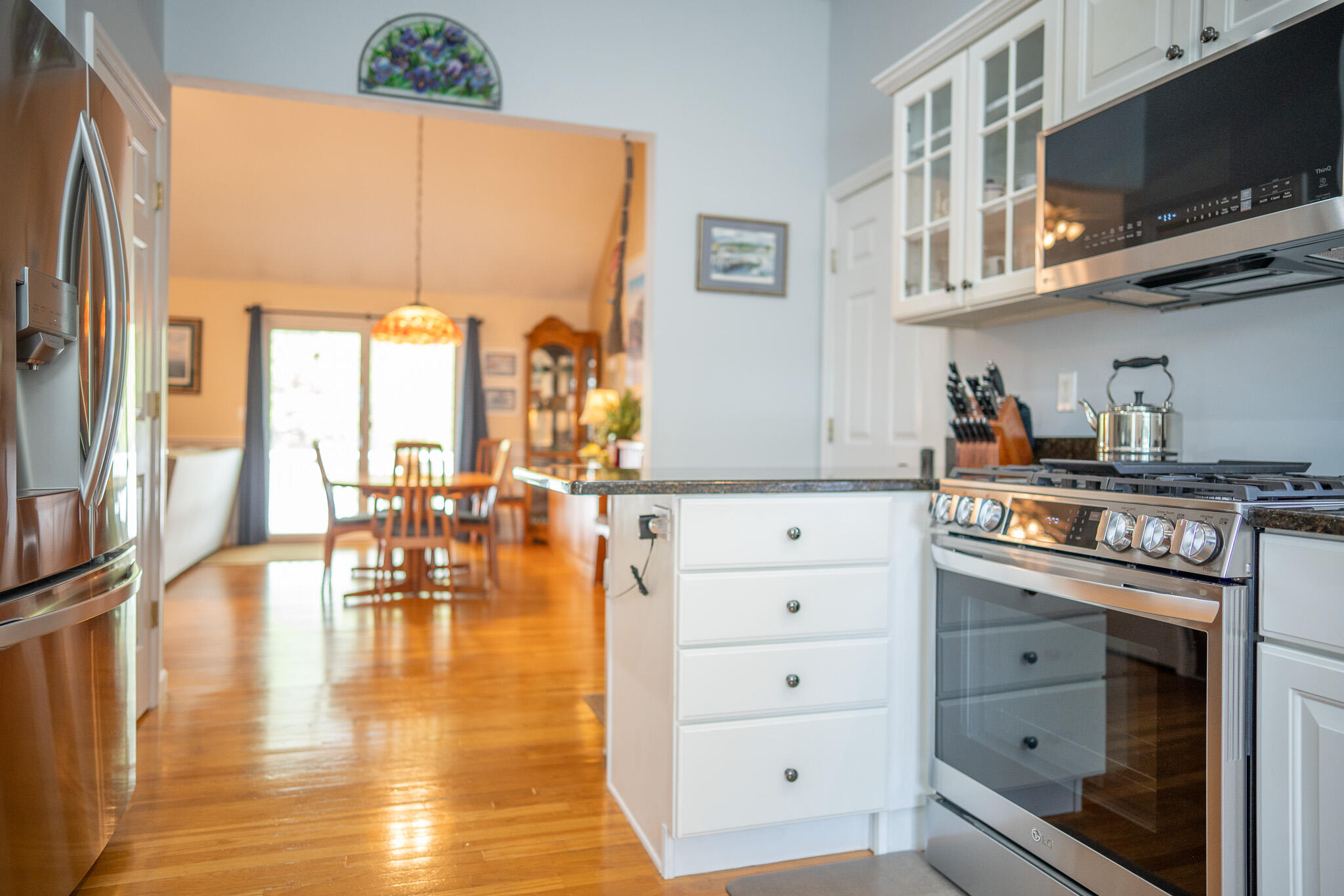 12 Sheffield Place Mashpee, MA 02649 - Photo 16 of 61 a kitchen with stainless steel appliances granite countertop a stove a sink and a microwave
