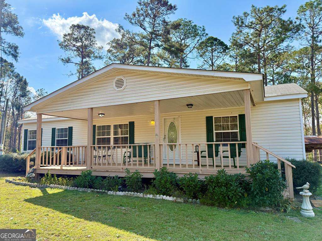 a front view of house with deck and outdoor seating