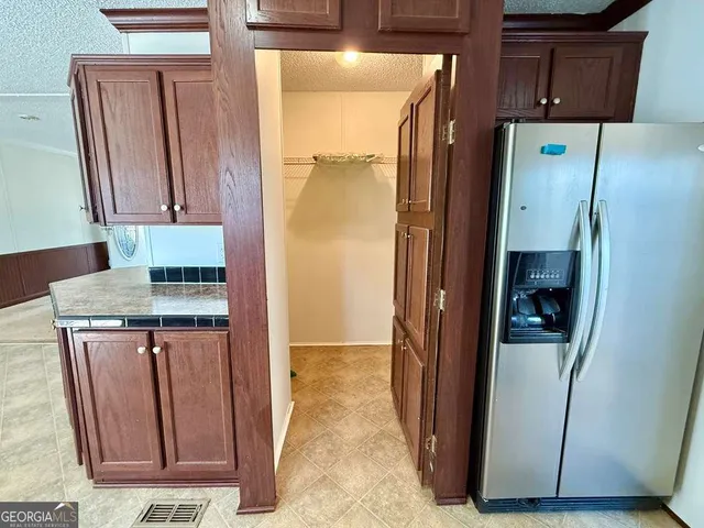 a bathroom with a granite countertop sink and mirror