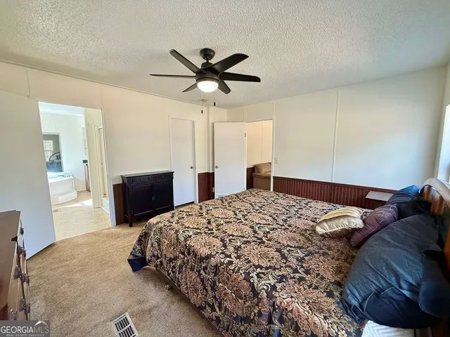 a large white kitchen with a large window