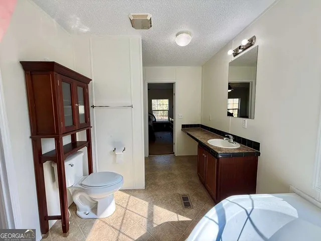 a bedroom with a bed and a lamp