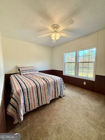a view of a house with a yard and sitting area