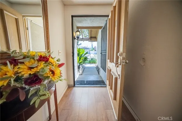 a view of a hallway with wooden floor and glass door
