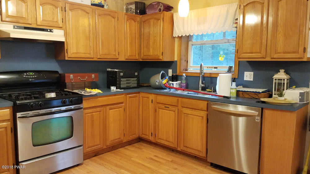 185 Fox Road Dingmans Ferry, PA 18328 - Photo 5 of 19 a kitchen with stainless steel appliances granite countertop a stove a sink and a microwave