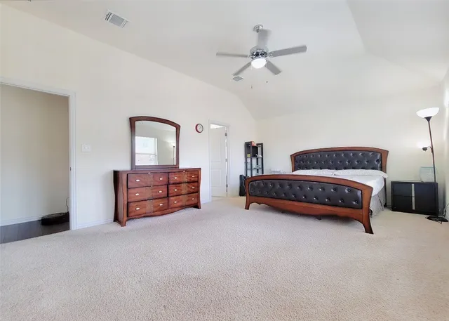 a bedroom with a bed dresser and a window